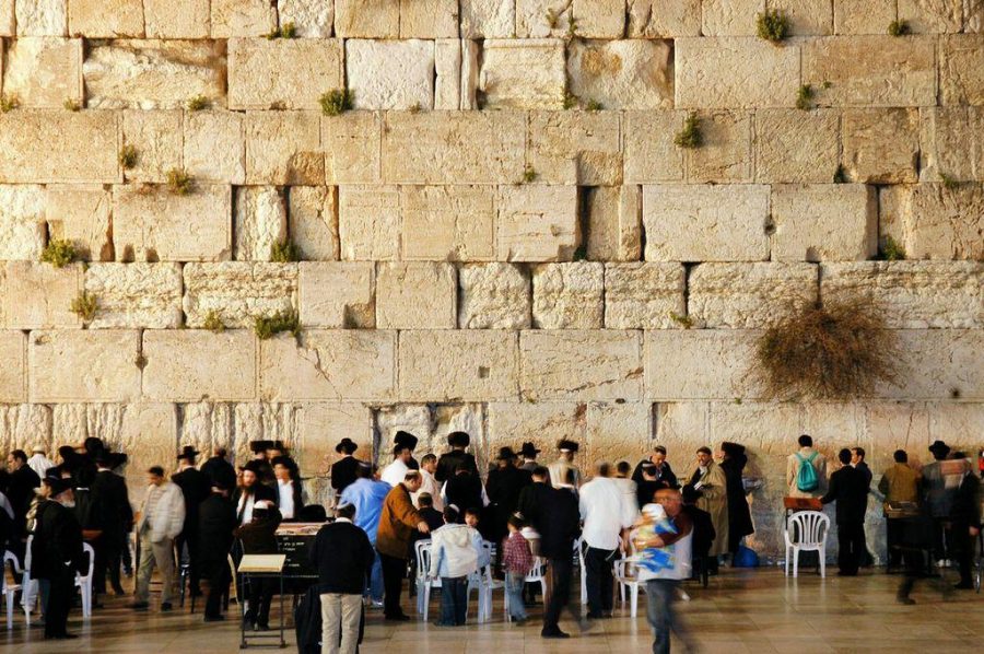 Pilgrimage plays a vital role in many religions, with worshippers traveling to visit sites like the Western Wall in Jerusalem. (Photo by Wayne Mclean/Wikimedia)