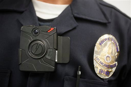 The NYPD is piloting a new program where police officers will wear body cameras to capture police actions. (Damian Dovarganes/AP)