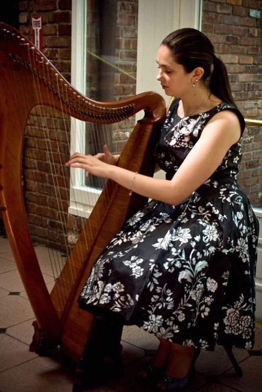 Alice shows great focus while honing her harp playing skills at an event. Courtesy of Alice Smyth