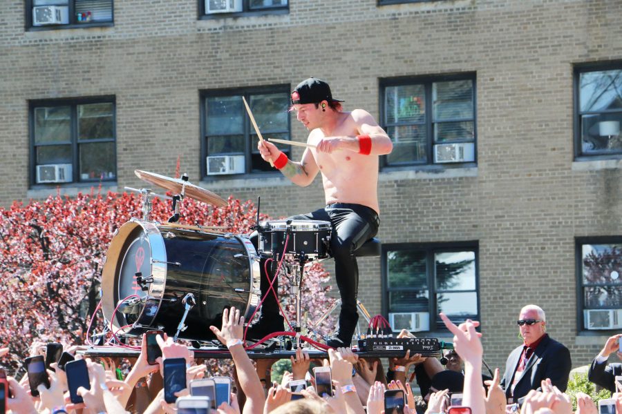Josh Dun of Twenty One Pilots is held up by students as he crowd surfs during Saturday's concert. Matthew Moore/The Fordham Ram