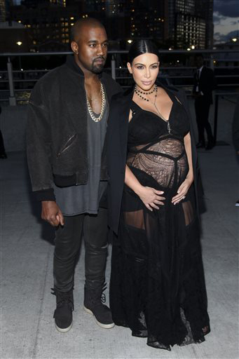 Kanye West and Kim Kardashian pose before attending the Givenchy show.