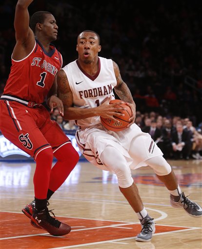 Fordhams Mandell Thomas (1) drives against St. Johns Phil Greene IV (1) during the first half of an NCAA college basketball game Sunday, Dec. 14, 2014, in New York.  St. Johns beat Fordham 74-53. (AP Photo/Jason DeCrow)