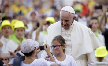 FILE - In this Tuesday, Aug. 4, 2015, file photo, Pope Francis poses for a photo as he arrives in St. Peters Square at the Vatican for an audience with with Altar boys and girls. Francis thrills Democrats with his teachings on climate change, social justice and immigration. At the same time, his message on life and the Catholic Churchs traditional opposition to abortion comfort Republicans. Both Democrats and Republicans are looking forward to Francis remarks to Congress next month. (AP Photo/Gregorio Borgia, File)