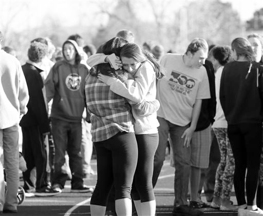 Students comfort each other at Arapahoe High School in Centennial, Colo., on Friday, Dec. 13, 2013, where a student shot at least one other student at a Colorado high school Friday before he apparently killed himself, authorities said. The shooter entered Arapahoe High School in a Denver suburb armed with a shotgun and looking for a teacher he identified by name, said Arapahoe County Sheriff Grayson Robinson. (AP Photo/Ed Andrieski)