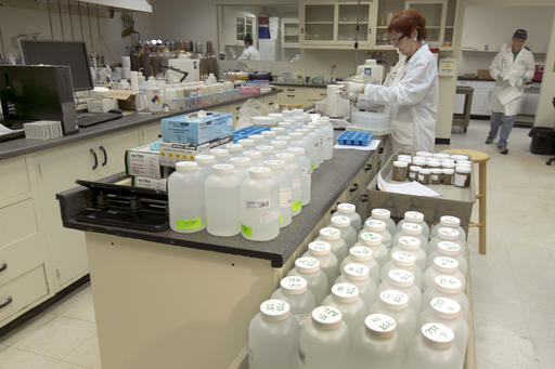 In this Friday, March 25, 2016 photo, Angela Stoica, center, supervisor of Inorganic Chemistry, works with drinking water samples at Aqua Pro-Tech Laboratories, in Fairfield, N.J. Responding to the crisis in Flint, Michigan, school officials across the country are testing for lead in the water flowing from classroom sinks and cafeteria faucets to reassure anxious parents or take action if they are surprised by the results. In March, the school district in Newark, New Jersey, shut off sinks and fountains in 30 buildings in response to high lead samples while offering to test as many as 17,000 children for lead contamination. (AP Photo/Richard Drew)