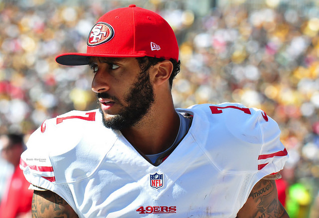 Colin Kaepernick, quaterback for the San Francisco 49ers, has faced scrutiny for kneeling during the national anthem. (Brook Ward/Flickr)