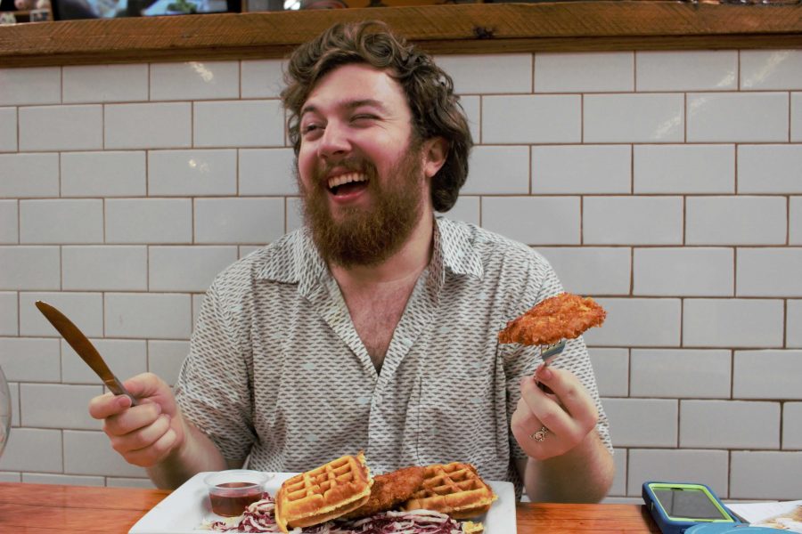 Pat enjoys his classic southern chicken and waffles while Caitlyn smiles with her omelette and potatoes. (Patrick Hood and Caitlyn Leterii/The Fordham Ram)