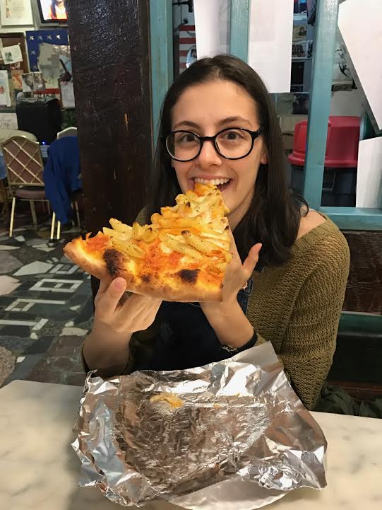 Caitlyn Letterii enjoys her slice of the newfound pizza place Pugsleys. (Courtesy of Caitlyn Letterii)