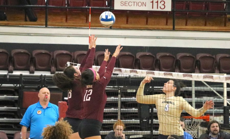 McKenna Lahr (18) and Nicole Freely (12) go up for a block at the net. Lahr put up 12 kills and 12 digs against Dayton (Courtesy of Julia Comerford/The Fordham Ram).