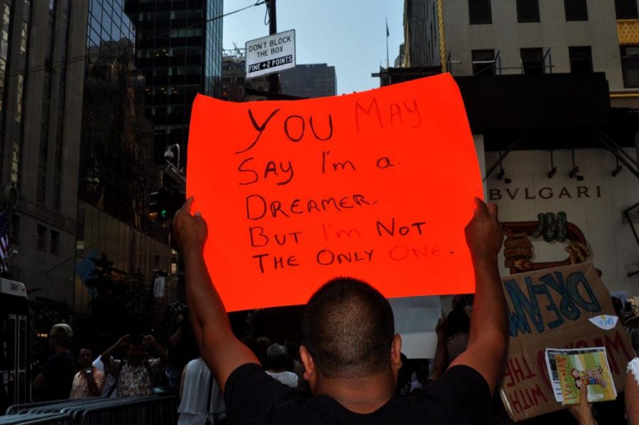 A protestor raises his voice against the repeal of DACA with a sign quoting the song Imagine by John Lennon. (Courtesy of Flickr)
