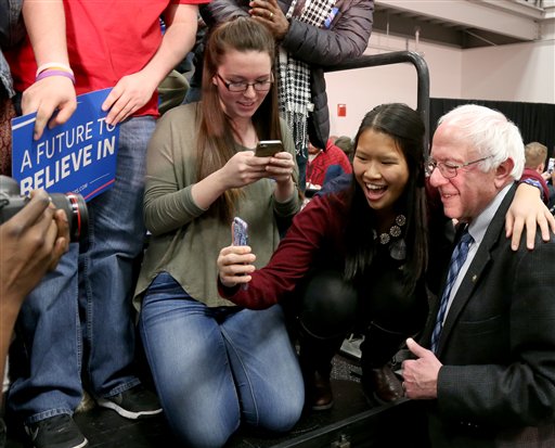 Democratic presidential candidate Sen. Bernie Sanders, I-Vt., poses for photos during a campaign stop, Monday, Jan. 4, 2016, in Manchester, N.H. (AP Photo/Mary Schwalm)