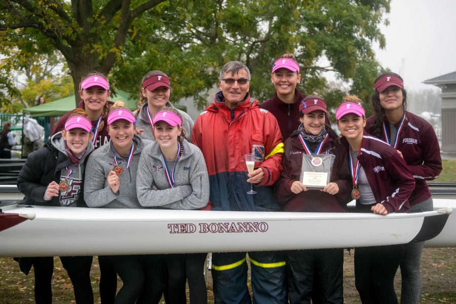 Rowing head coach Ted Bonanno, center, poses with the team and a new boat. (Andrea Garcia/The Fordham Ram)