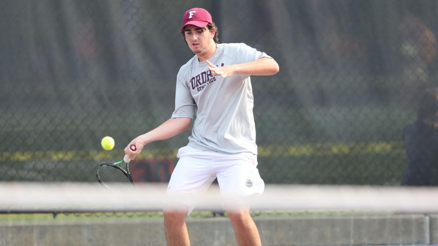 Lutwin de Macar hits a forehand. He won his singles match 4-6, 6-4, 10-5, but lost his doubles match 3-6 (Courtesy of Fordham Athletics).