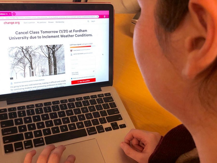 A student looks at the snow day petition on their computer. (Julia Comerford/The Fordham Ram)
