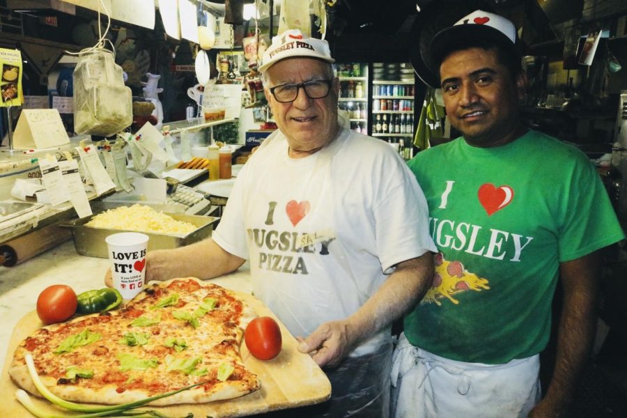 Sal and Pugsleys employee pose with a heart shaped pizza for Valentines Day. (Julia Comerford/The Fordham Ram)