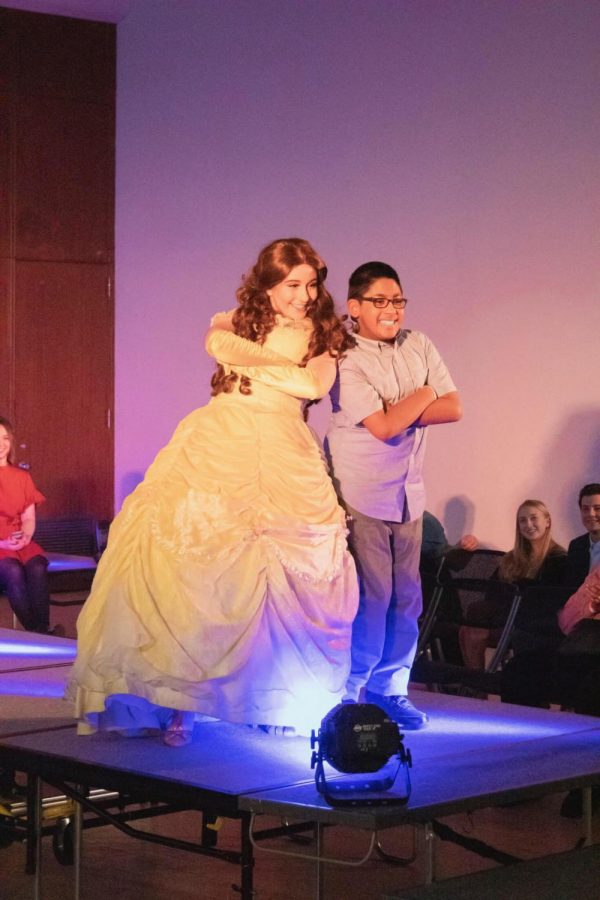 Belle from Moment of Magic walks the runway with one of the Special Olympians. (Joe Byrnes/ The Fordham Ram)