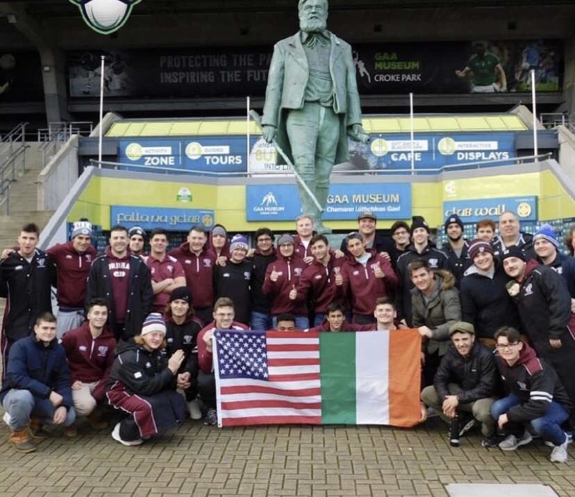The+team+poses+with+an+American+and+Irish+flag+in+front+of+the+Gaelic+Athletic+Association+Museum+in+Croke+Park.+%28Courtesy+of+Fordham+Rugby%29