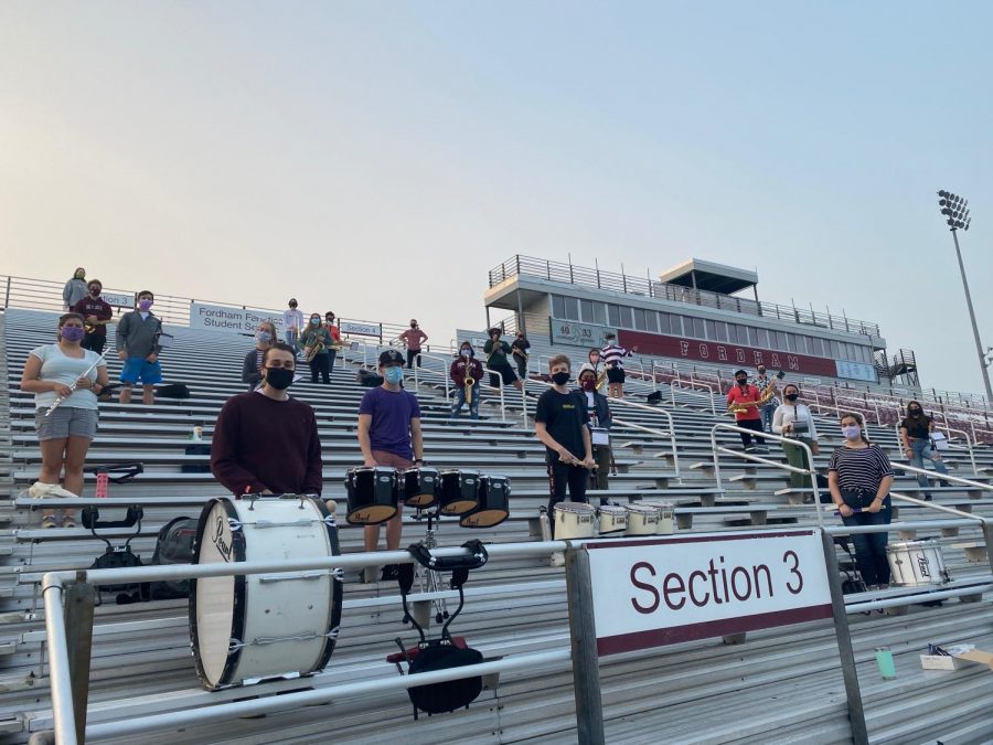Fordham Pep Band members practice social distancing on the football bleachers while rehearsing. (Courtesy of Fordham Pep Band)