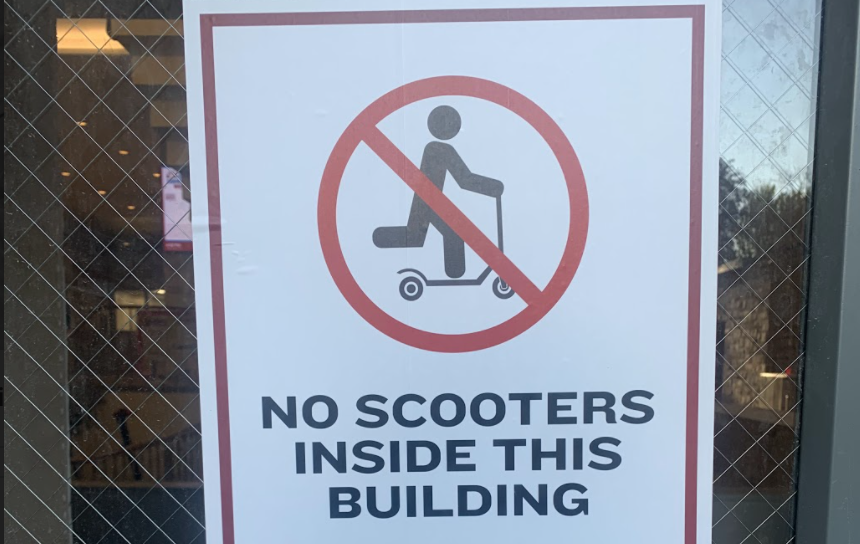 Signs have recently been posted on building entrances around Rose Hills campus prohibiting indoor scooter use. (Abbey Delk/The Fordham Ram)