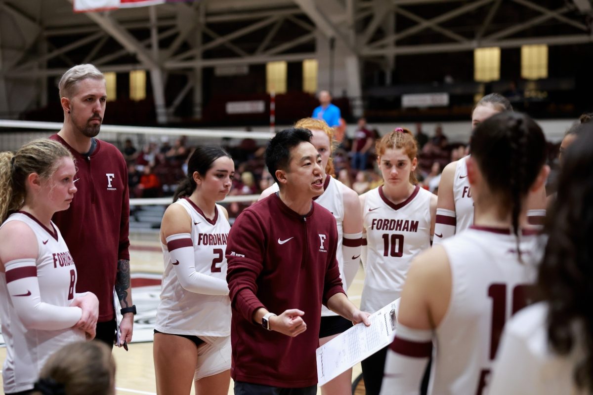 Head coach Ian Choi speaks animatedly with the 2023 Fordham volleyball team. (Courtesy of Fordham Athletics) 