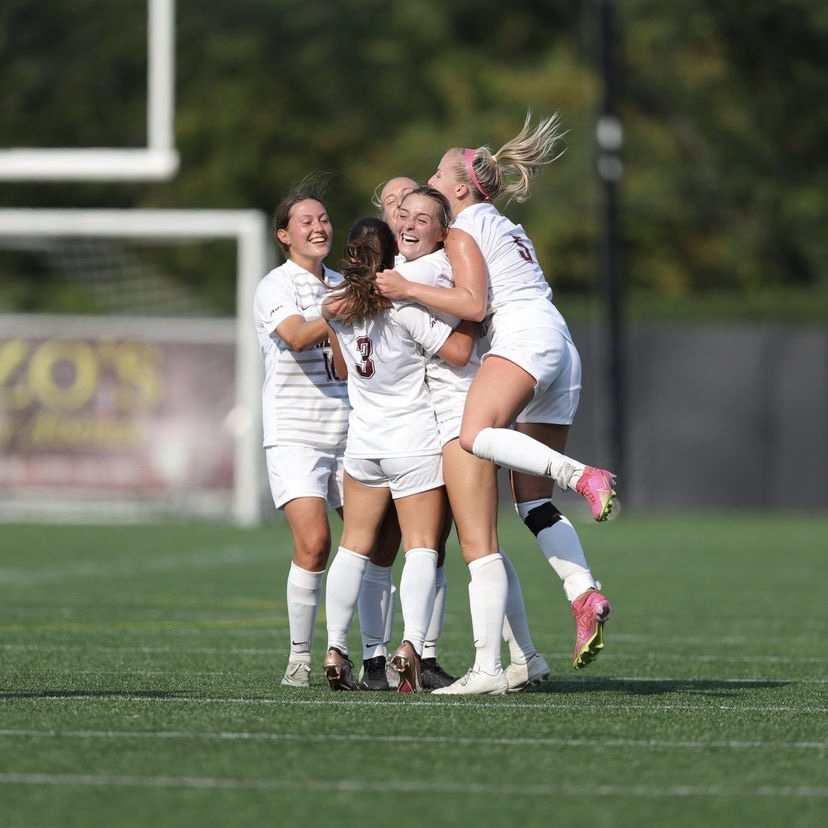 The Fordham women's soccer team celebrates on the field. (Courtesy of Fordham Athletics)