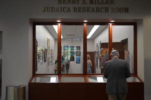 A man observes Benjamin's exhibit on the fourth floor of Walsh Library. (Courtesy of Nora Malone/The Fordham Ram)