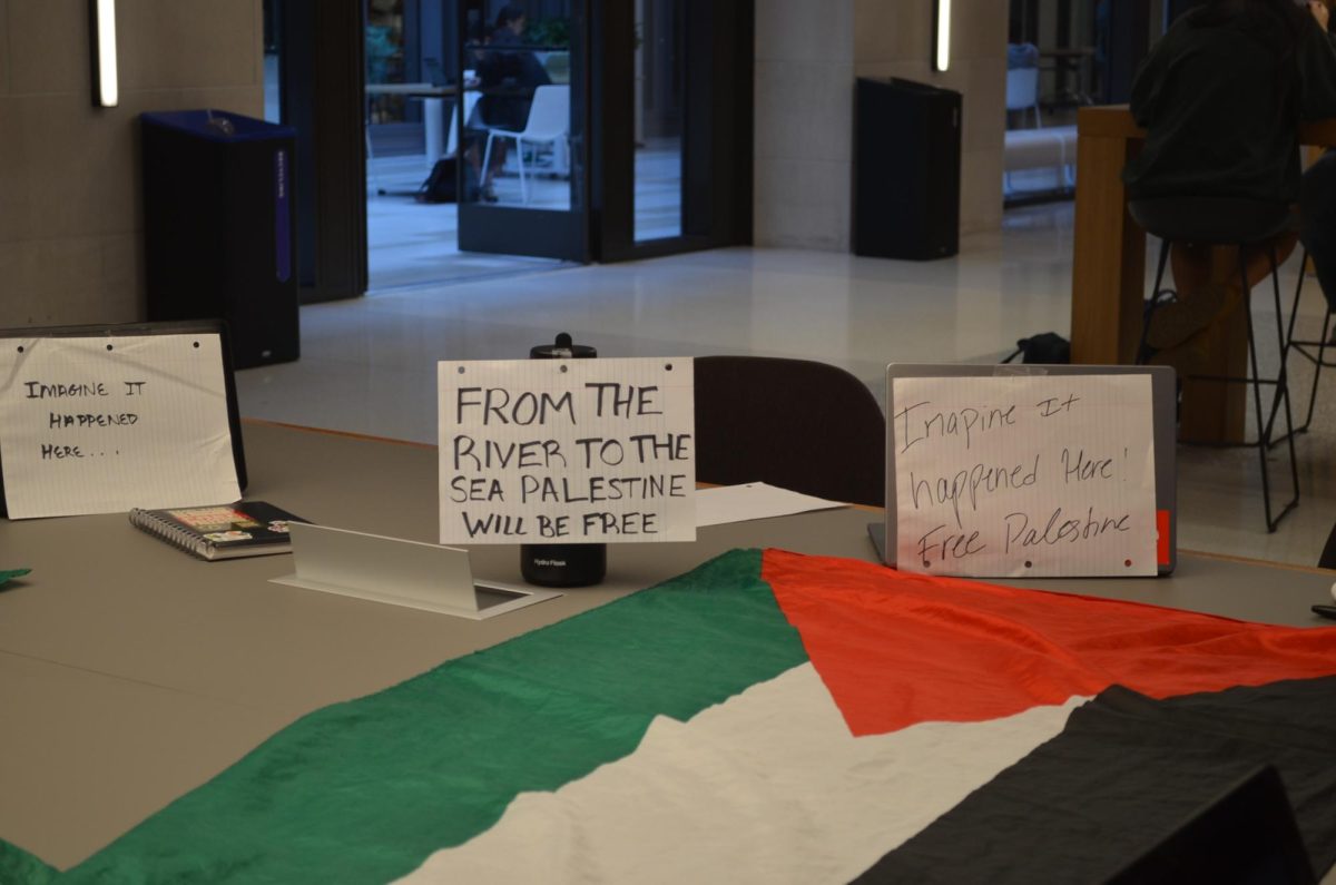 Students had signs and flags in the center table in the McShane Campus Center (Photo by Nora Malone/The Fordham Ram). 