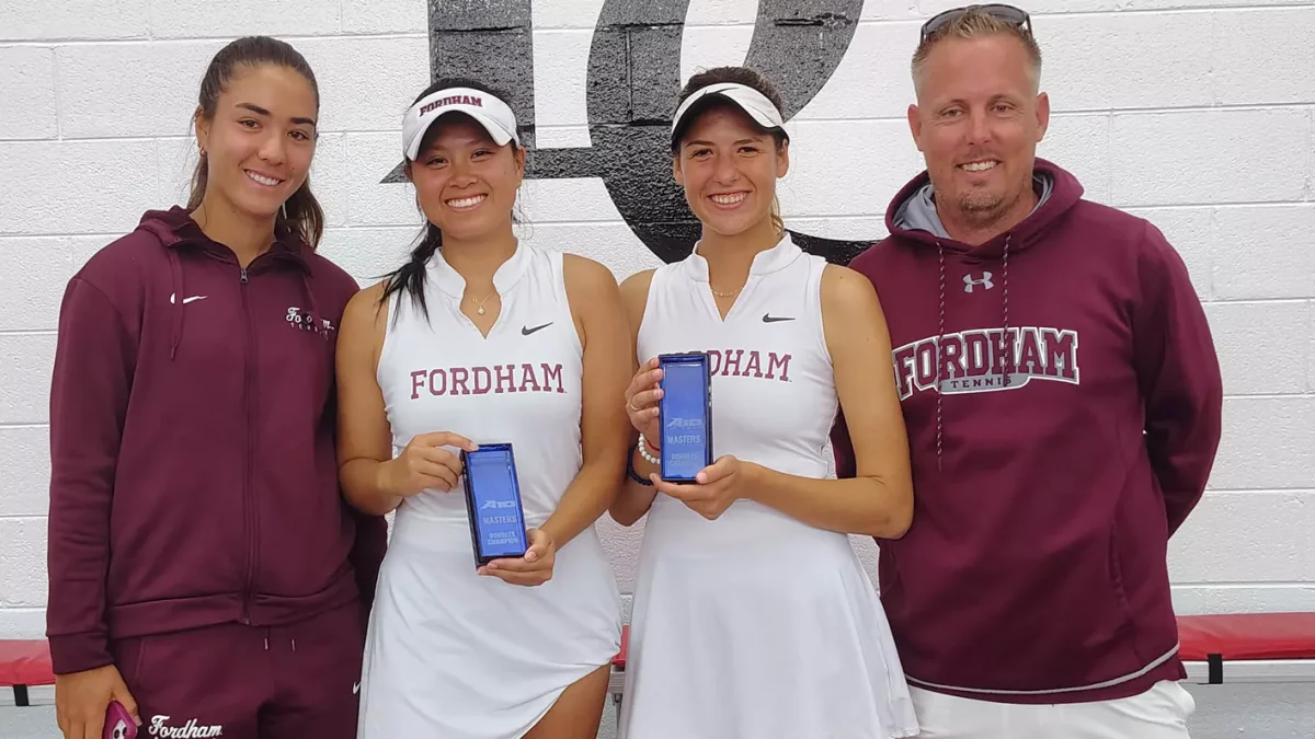 Julianne Nguyen and Nevena Kolarevic  show off their hardwood after winning the A-10 Masters tournament. (Courtesy of Instagram/@fordhamwomenstennis)