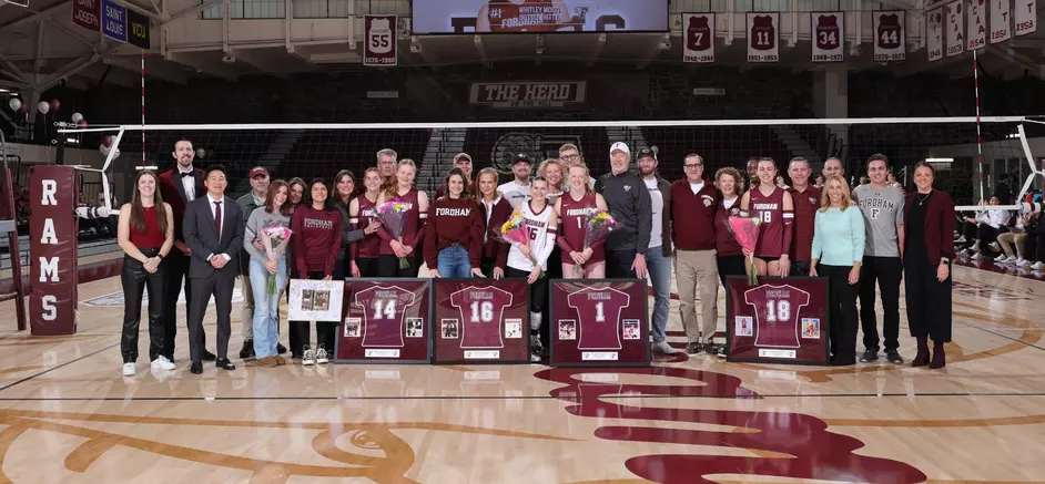 From left to right, Lauryn Sweeney, Ryan Naumann, Whitley Moody and Audrey Hayes line up with their families for Senior Day. They represent a senior class responsible for propelling Fordham Volleyball to unparalleled heights. (Courtesy of Fordham Athletics)