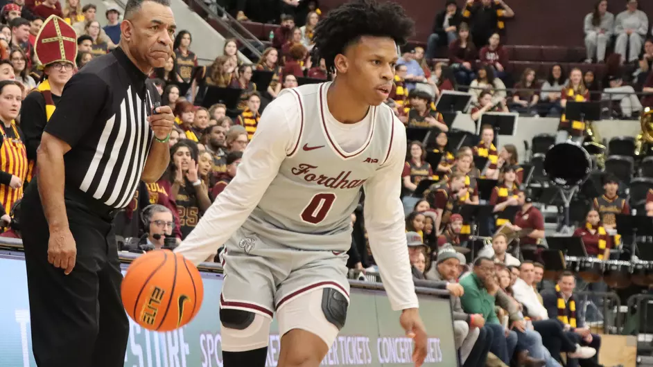 Japhet Medor handles the ball amidst Rambler defenders (Courtesy of Fordham Athletics).