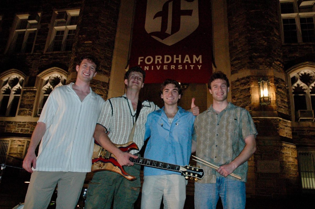 Student band Code of Conduct stands in front of Keating after performing (Martinez Reyes for The Fordham Ram)