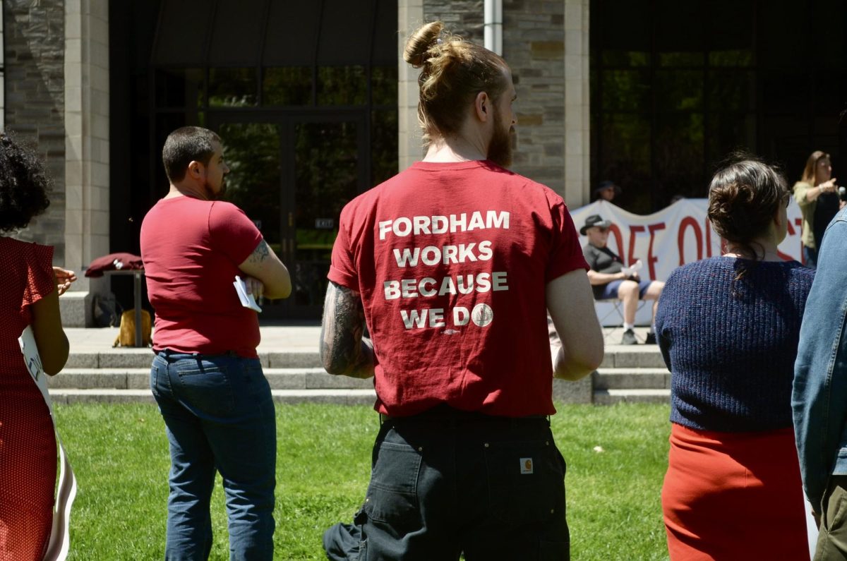 A faculty member stands in front of Walsh Family Library (Nora Malone/The Fordham Ram)