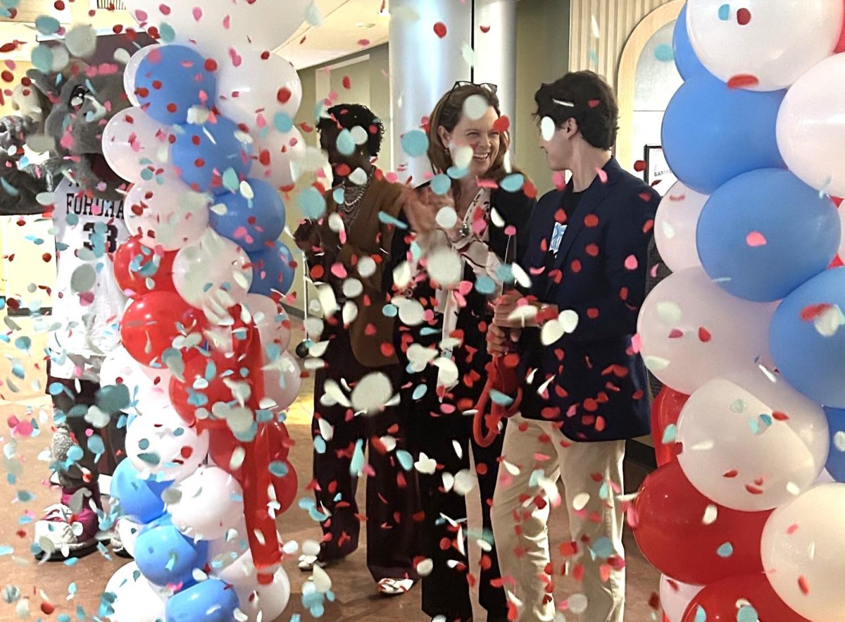 University President, Tania Tetlow, joined by Saxbys Student CEO, Aiden Engelmann in the ribbon cutting ceremony. (Lalleyah Camara/The Fordham Ram)