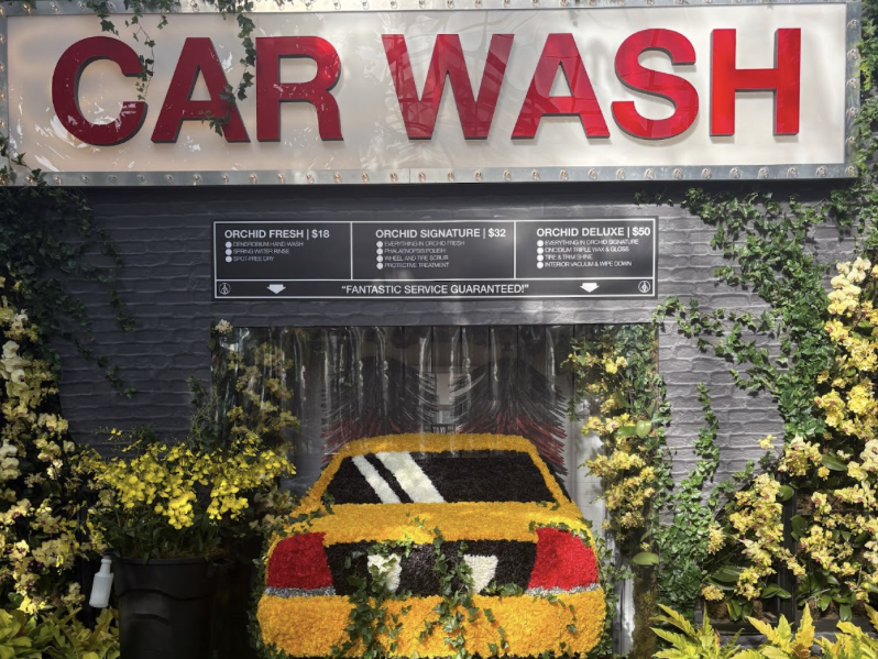 One of Mr. Flower Fantastic's orchid displays where an arrangement of flowers portray a classic yellow taxi cab.