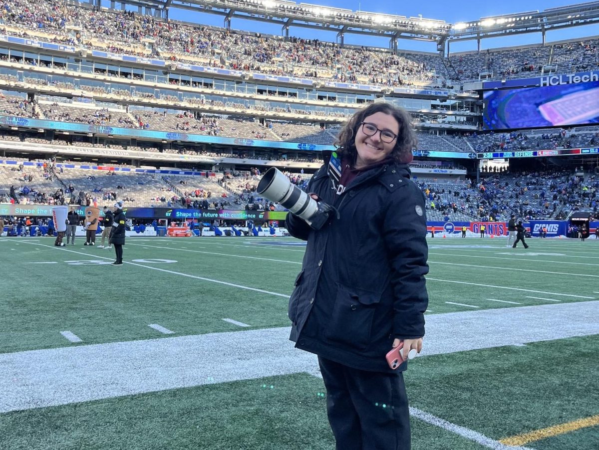 Cristina Stefanizzi taking photos at a New York Giants game at MetLife Stadium.