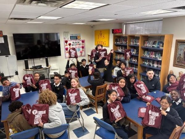 SIS and Fordham students showing off the school supply packs.