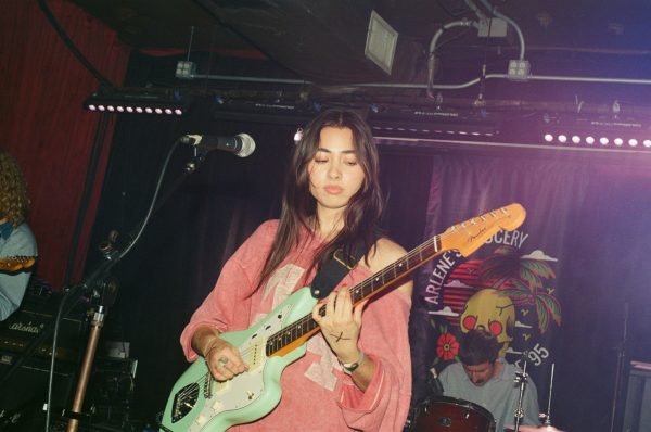 Lorelei jamming out on the stage with her electric guitar.