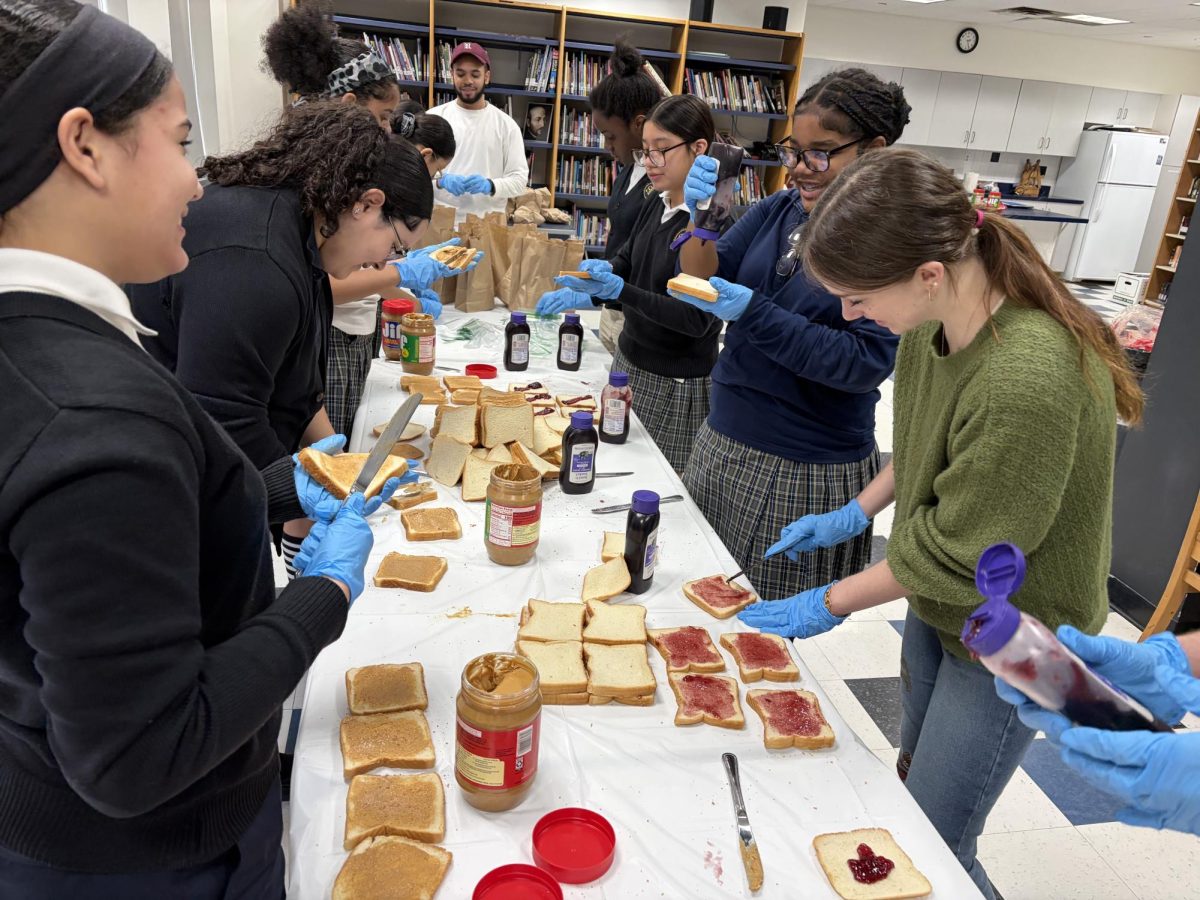 St. Ignatius and Fordham University students making sandwiches together.