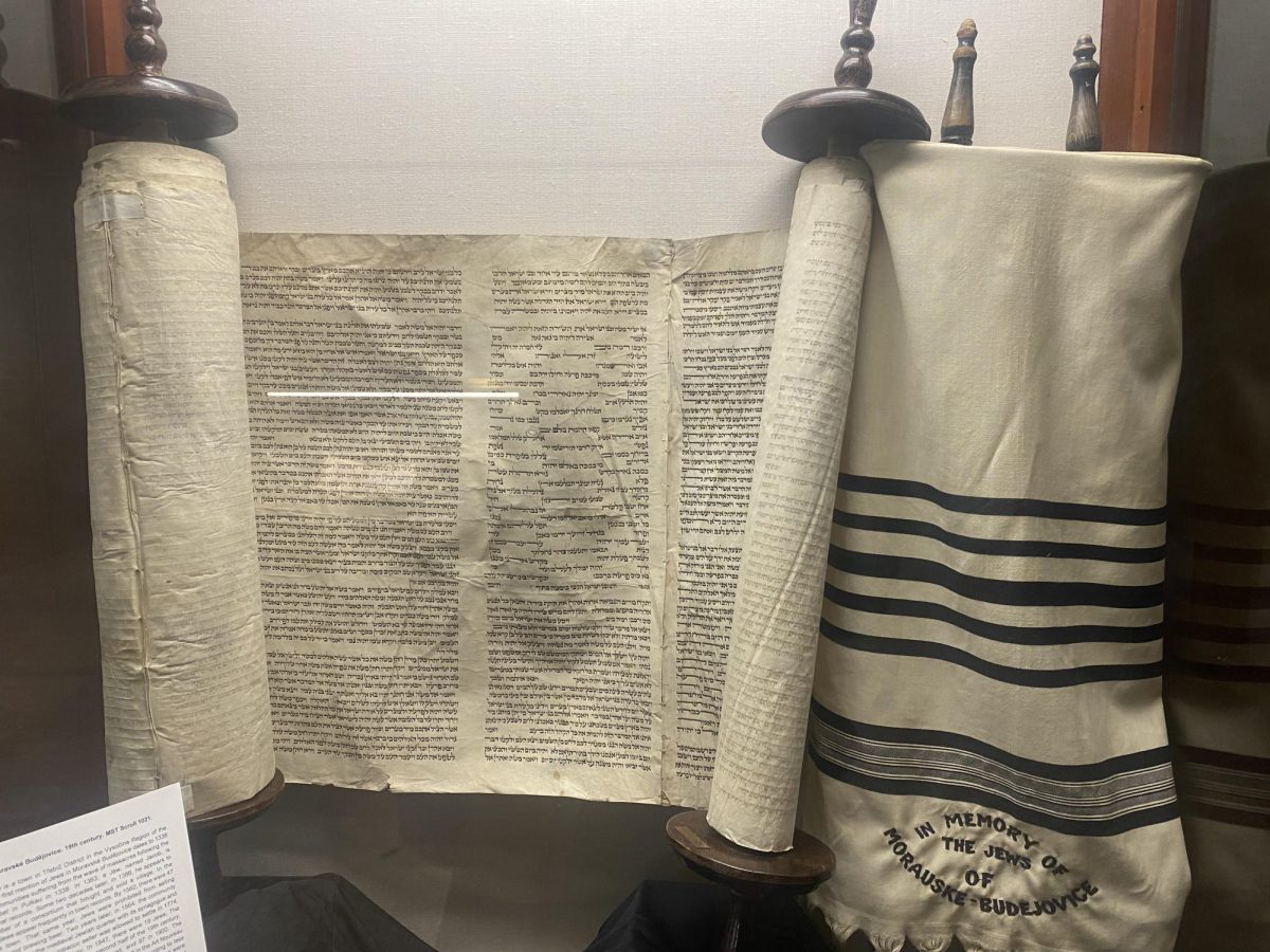 A torah scroll and wimpel on display in Walsh Library.