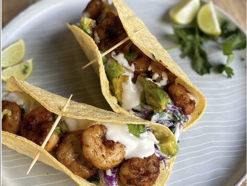 A pair of delicious shrimp tacos perfect for college students to enjoy.