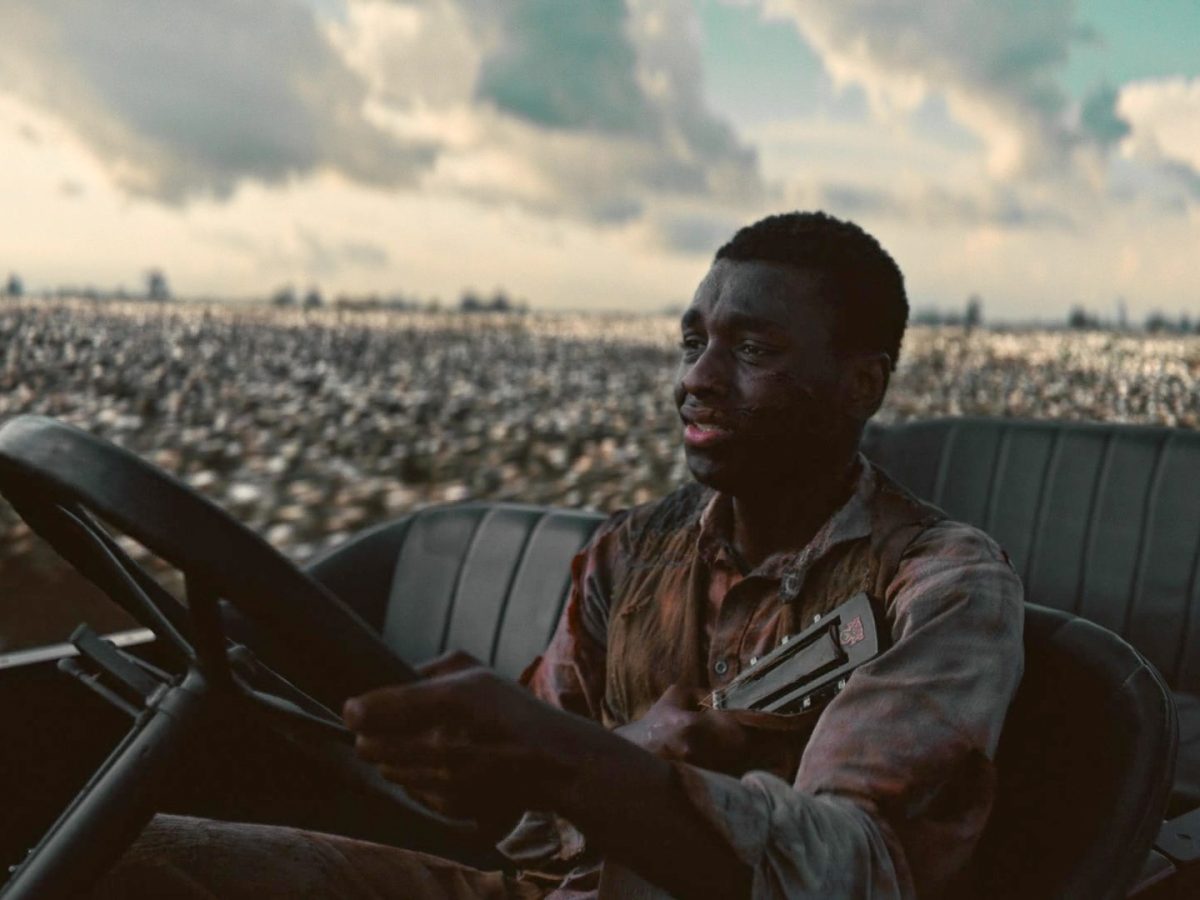 Sammie Moore (Miles Caton) drives while clutching his half-broken guitar