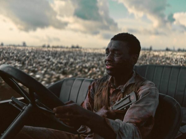 Sammie Moore (Miles Caton) drives while clutching his half-broken guitar