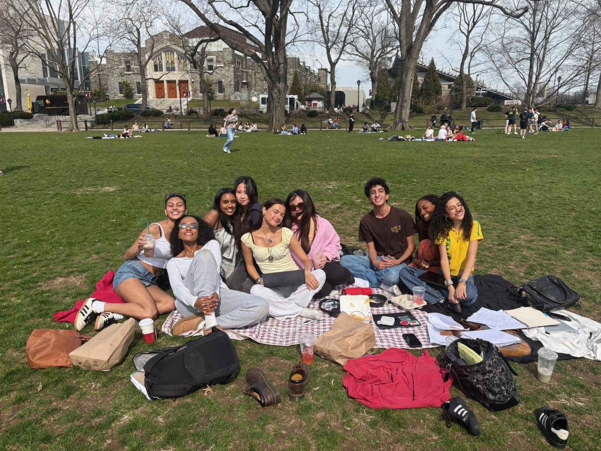 A group of Fordham students lay out on the grass to soak up some sun.